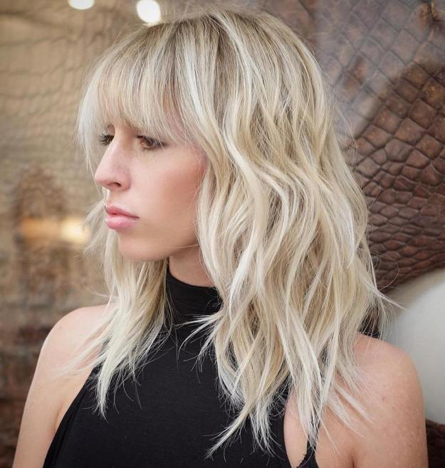 Blonde Layered Hairstyle With Bangs