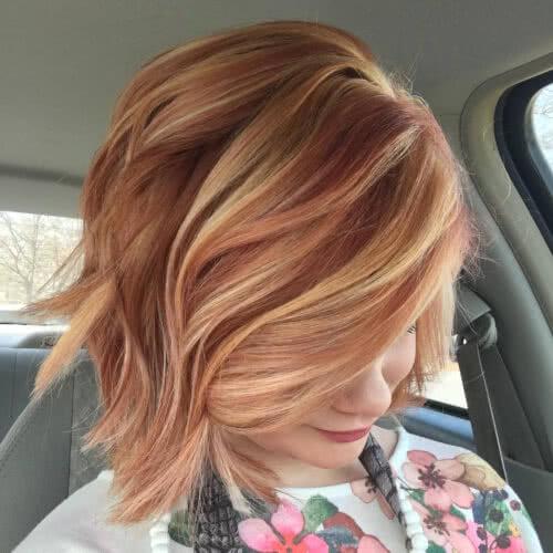 A fun and flirty short choppy bob cut with blonde highlights