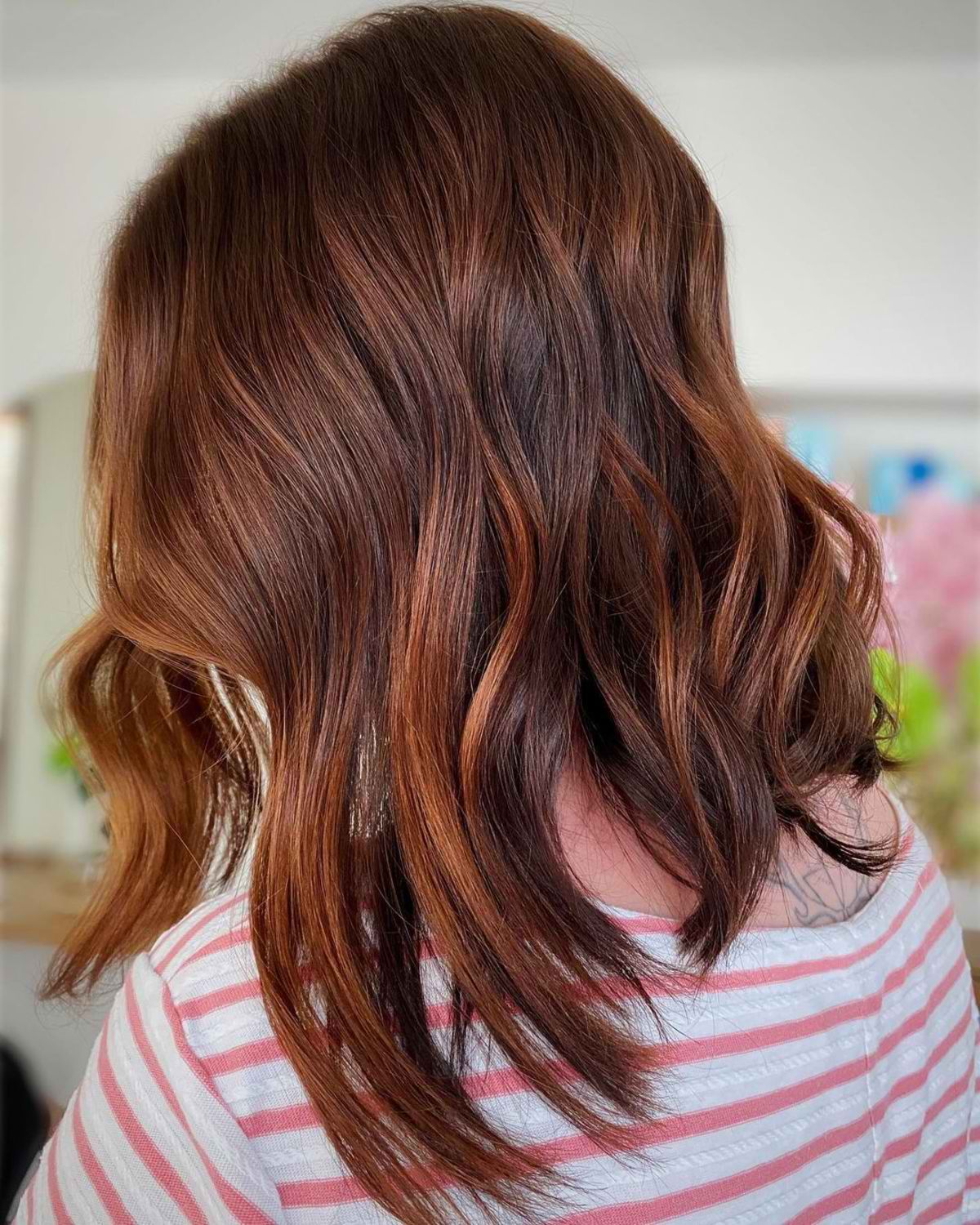 A playful short haircut with auburn hair color for thick hair