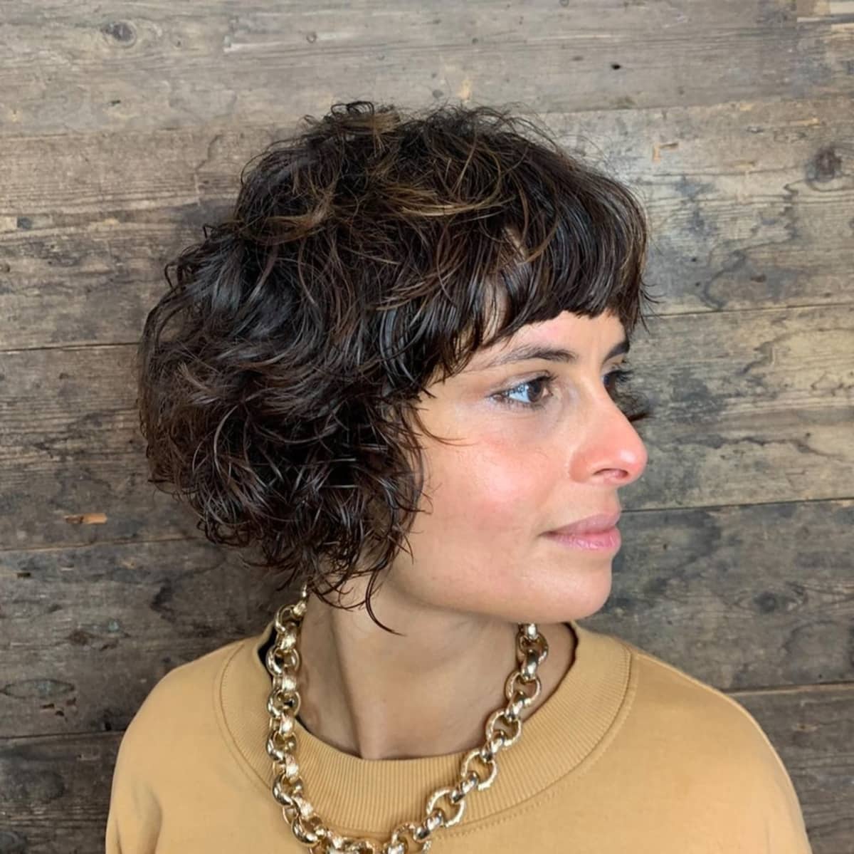 curly inverted bob with bangs