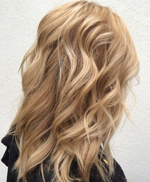 medium layered sandy blonde hairstyle