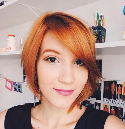 red asymmetrical bob with side bangs