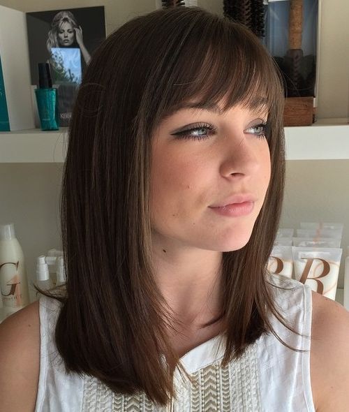 straight medium-length brunette hairstyle with bangs