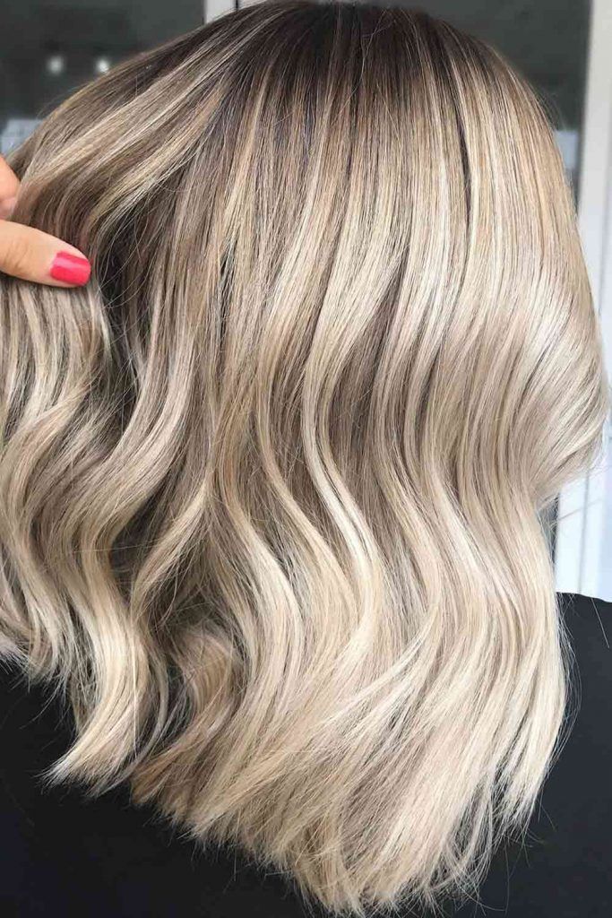 Curly Dirty Blonde Hair With Subtle Highlights