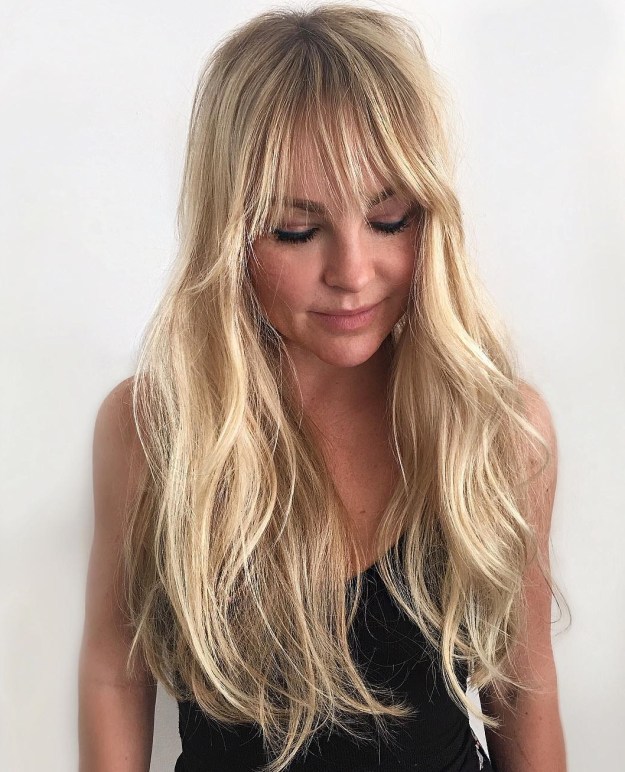 Long Layered Blonde Haircut With Bangs