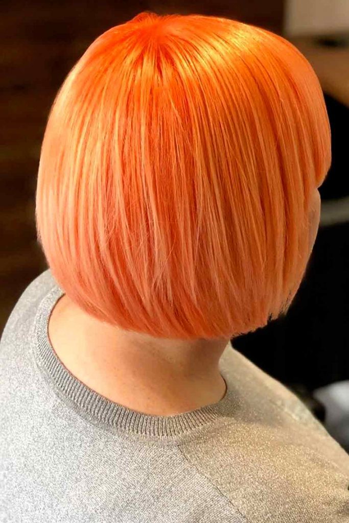 Short haircut with bright orange color looks great