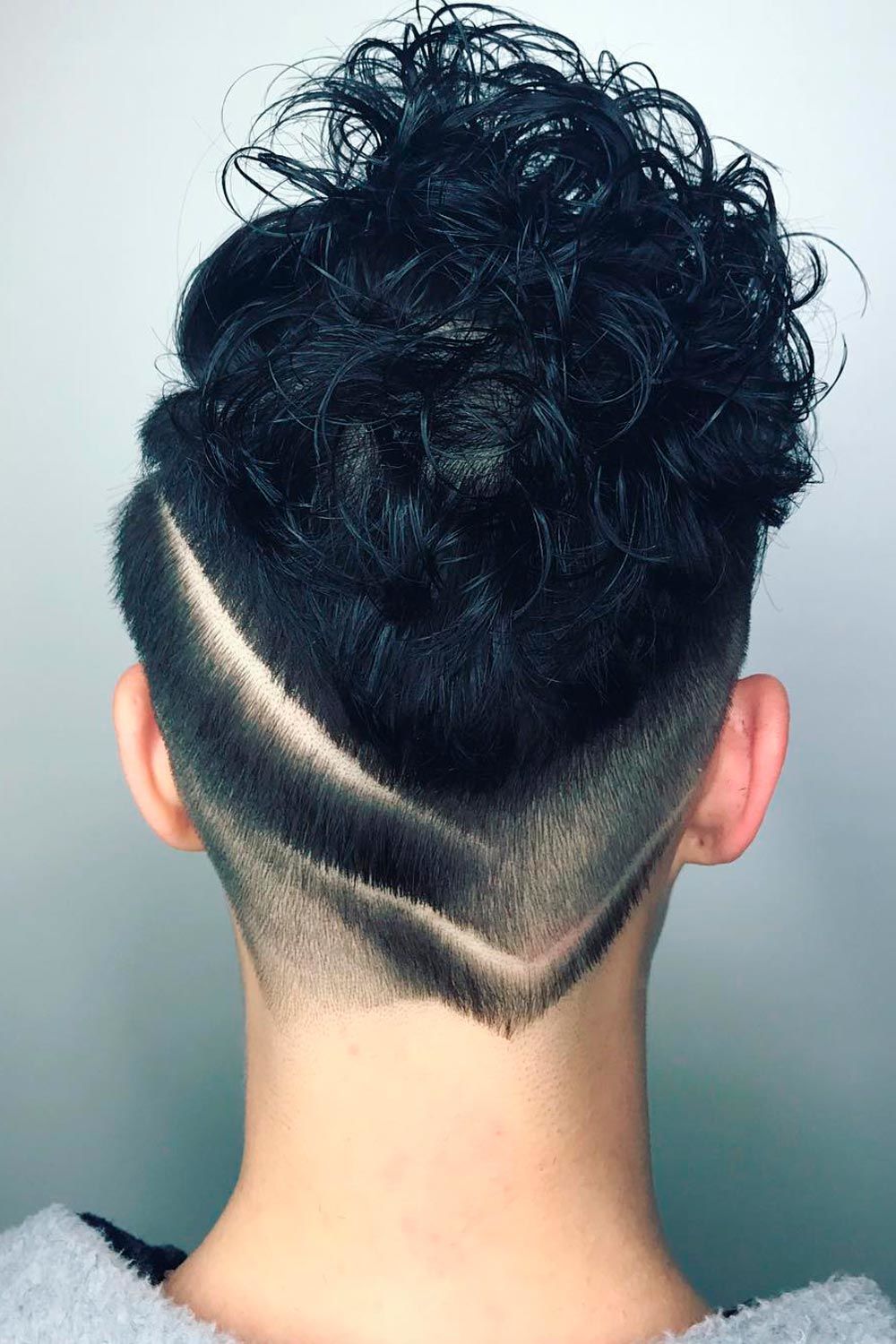 Taper Curly Haircut With Undercut Design