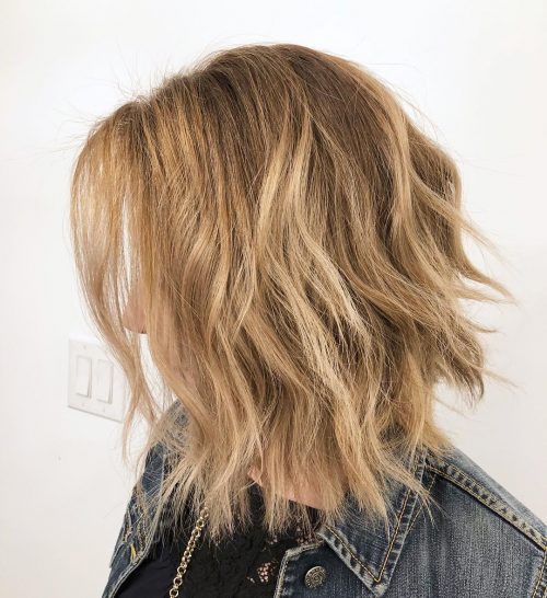 A frizzy shoulder-length haircut with waves