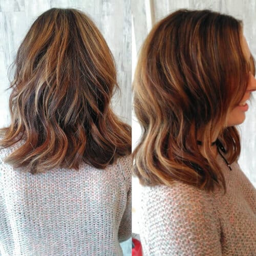 A multi tonal dark brown shoulder-length hair cut and color