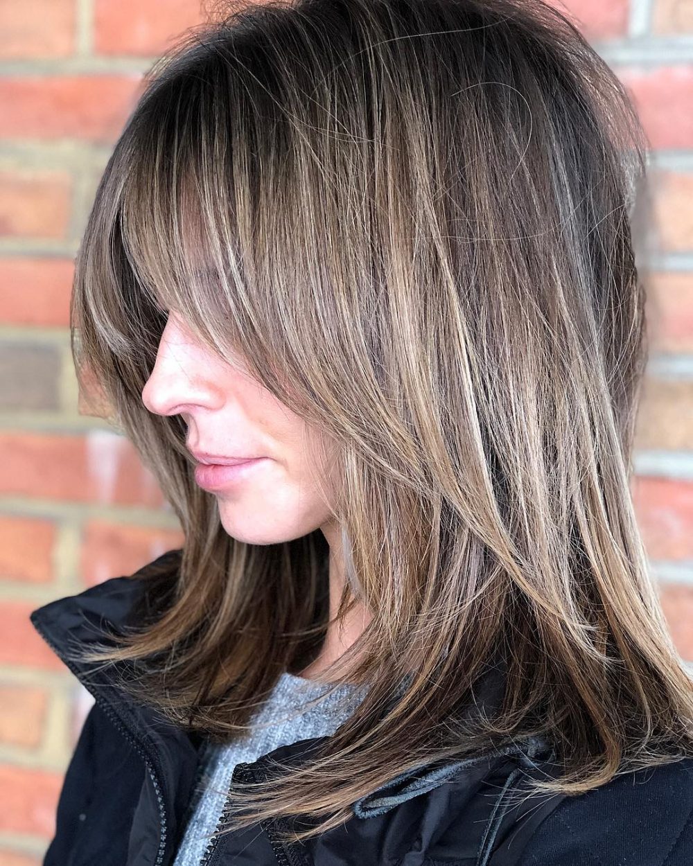 A polished bronde colored shag with bangs