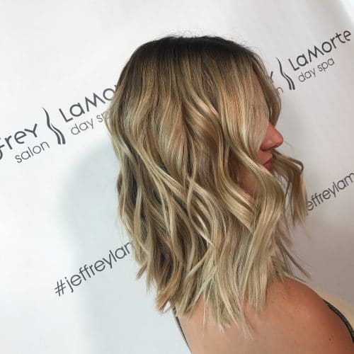 A trendy shoulder cut long bob hairstyle with honey blonde hair color