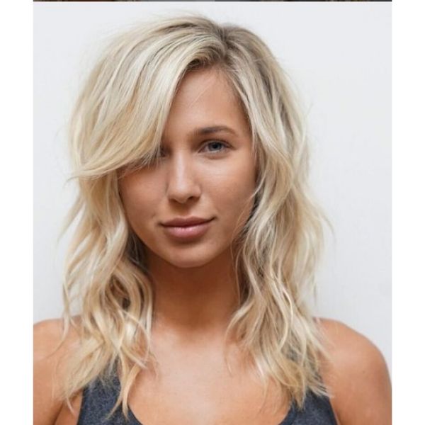 Blonde Medium Long Haircuts For Wavy Hair With Side-swept Bangs