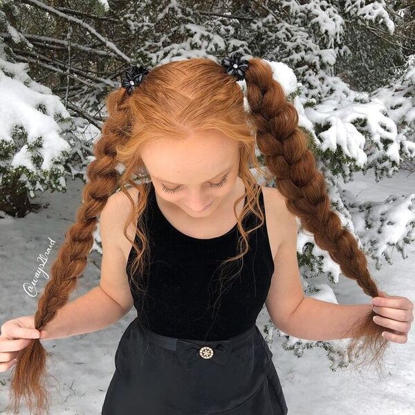 Braided Pigtails - a woman wearing black top and skirt