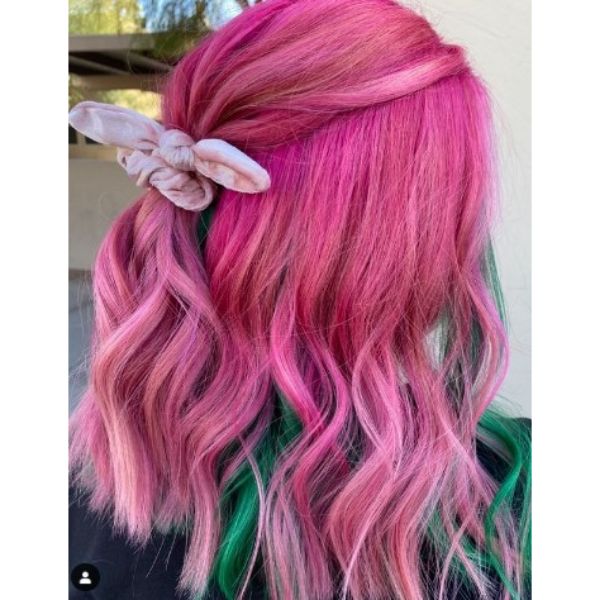 Bright Pink Colored Medium Haircut With Green Underliights and Half Ponytail