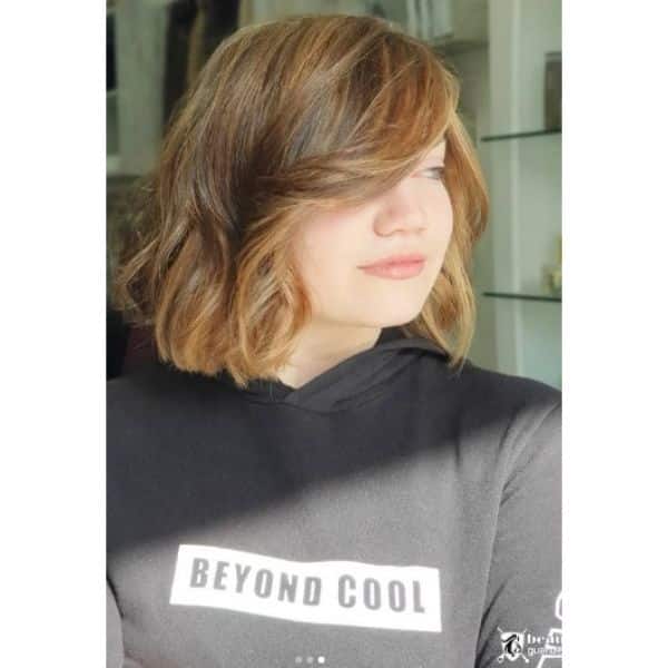 Caramel Colored Medium Haircut For Wavy Hair with Side Fringe