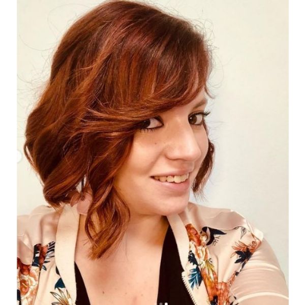 Cinnamon Red Medium Haircut For Wavy Hair With Side Swept Fringe