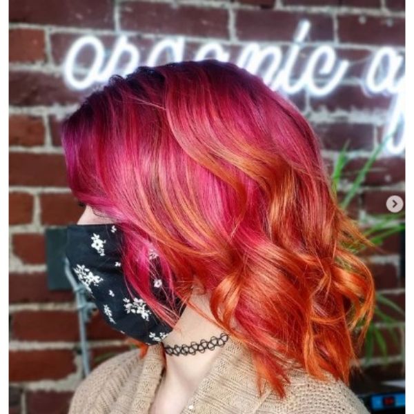 Coral Pink Long Curly Bob With Orange Highlights