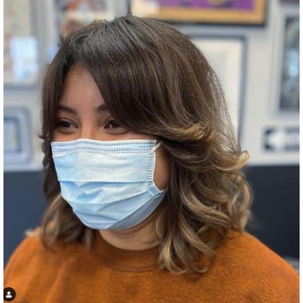 Curly Long With Curtain Bangs And Blonde Highlights
