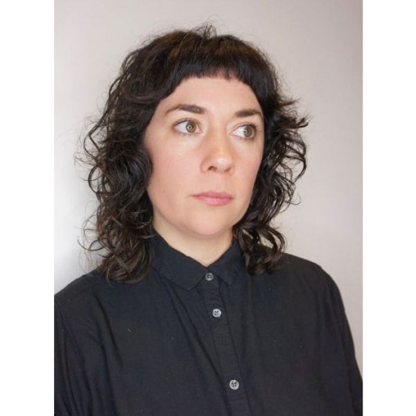 Dark Brunette Shag Haircut with Tiny Bangs