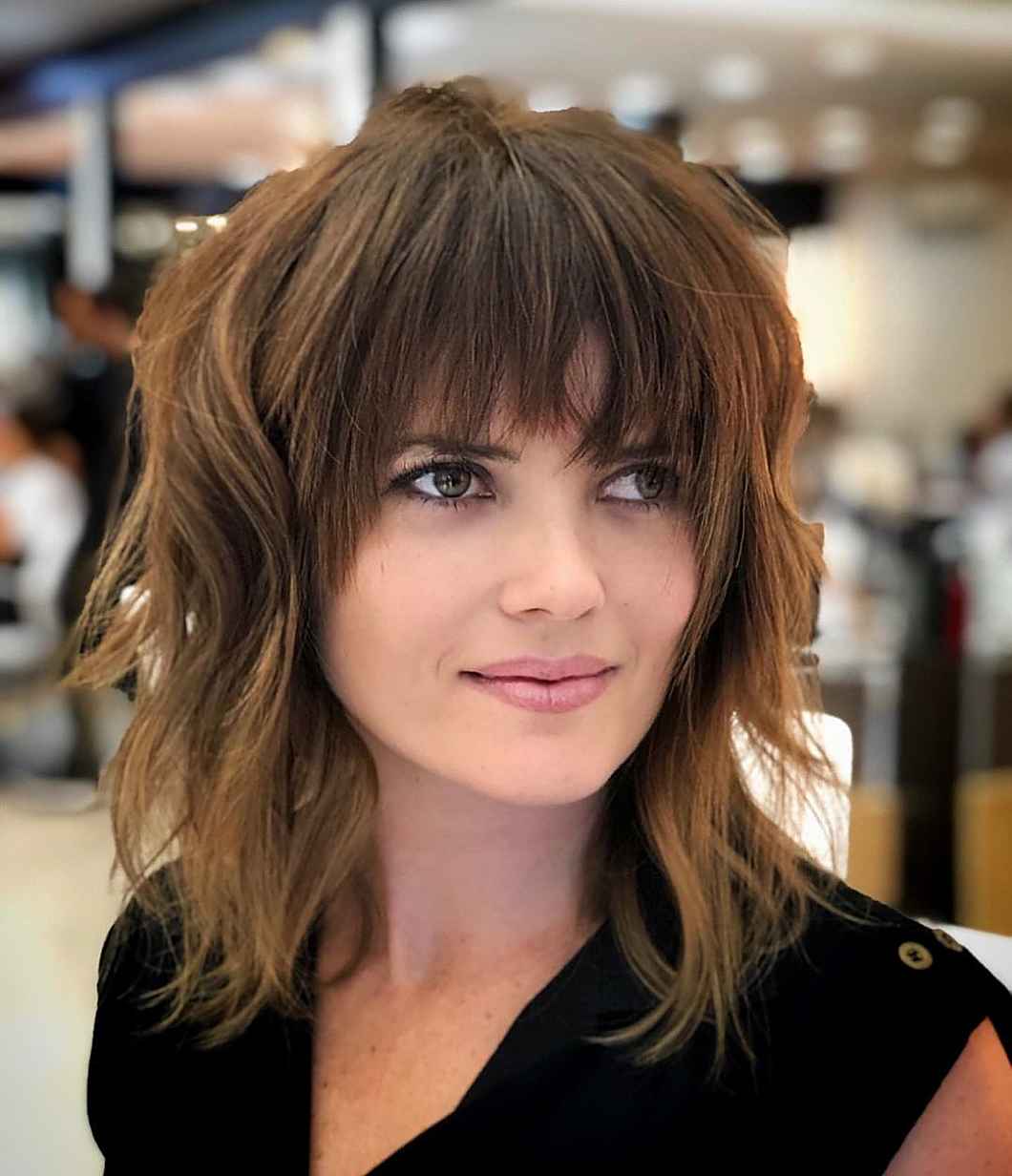 dark wavy angled bob with wispy bangs