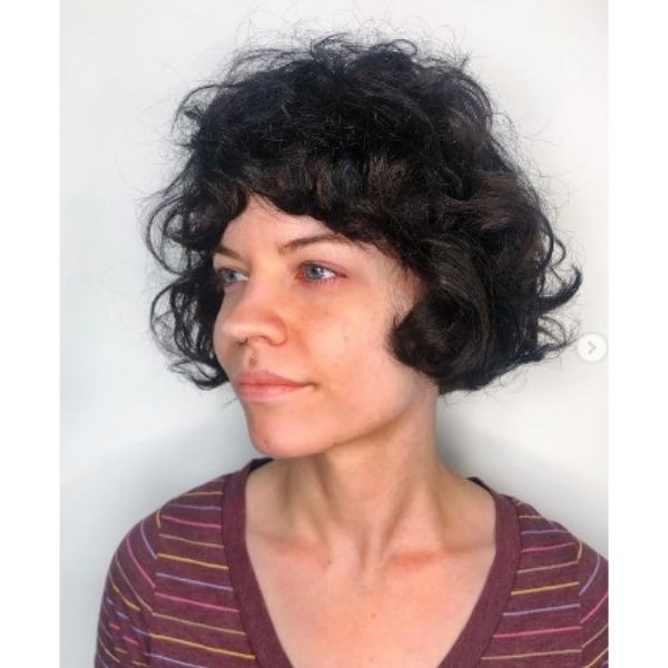 French Curly Bob With Full Bangs Hairstyle