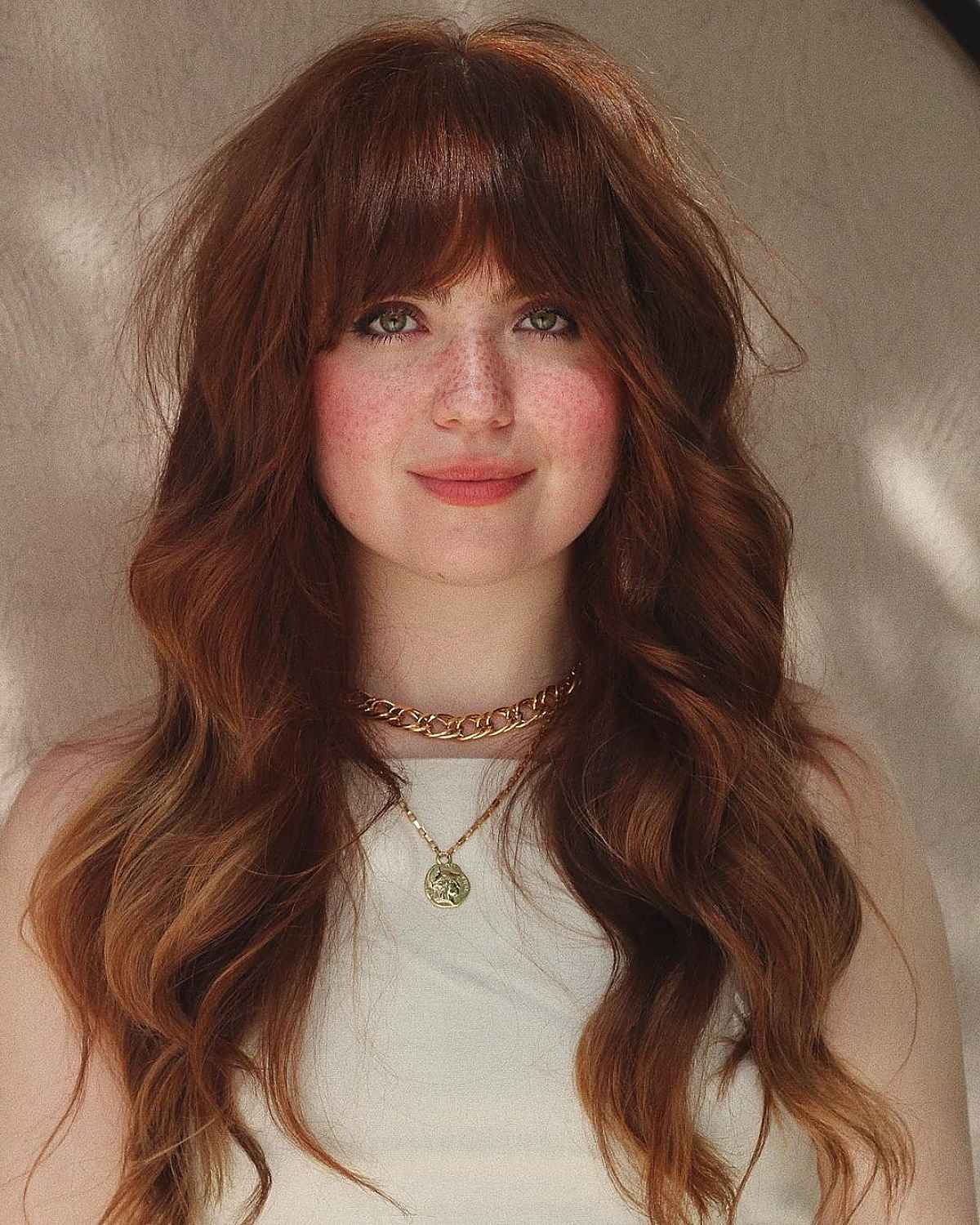Long hair with bangs for a round face shape