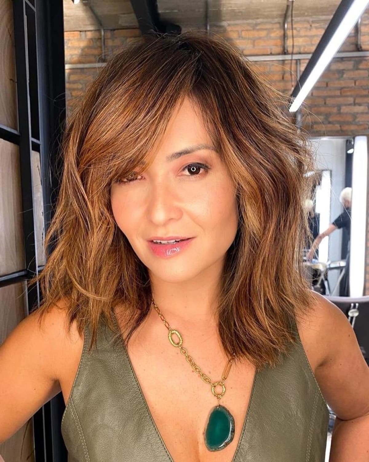 Medium layered cut with side swept bangs for square faces