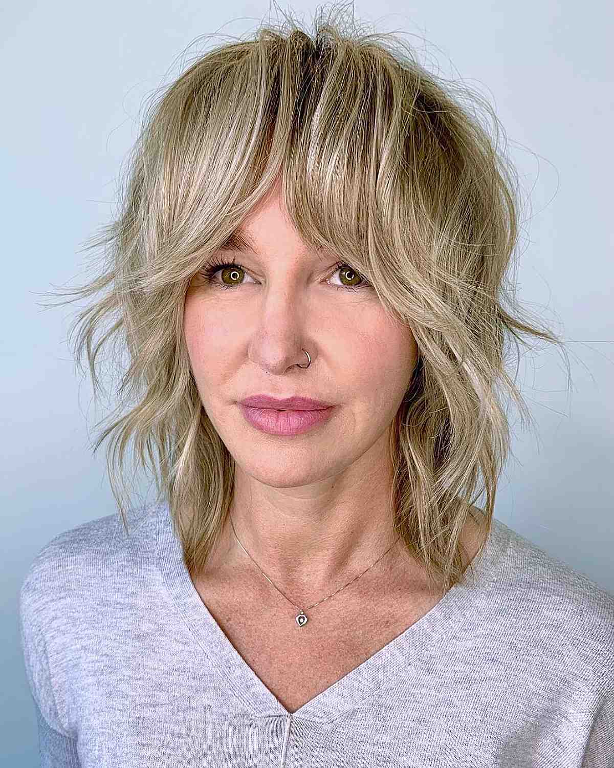 medium layered shag with blonde highlights