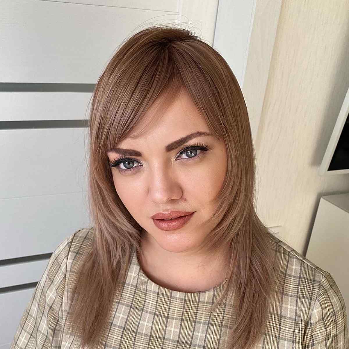 Mid-length layered cut with side bangs