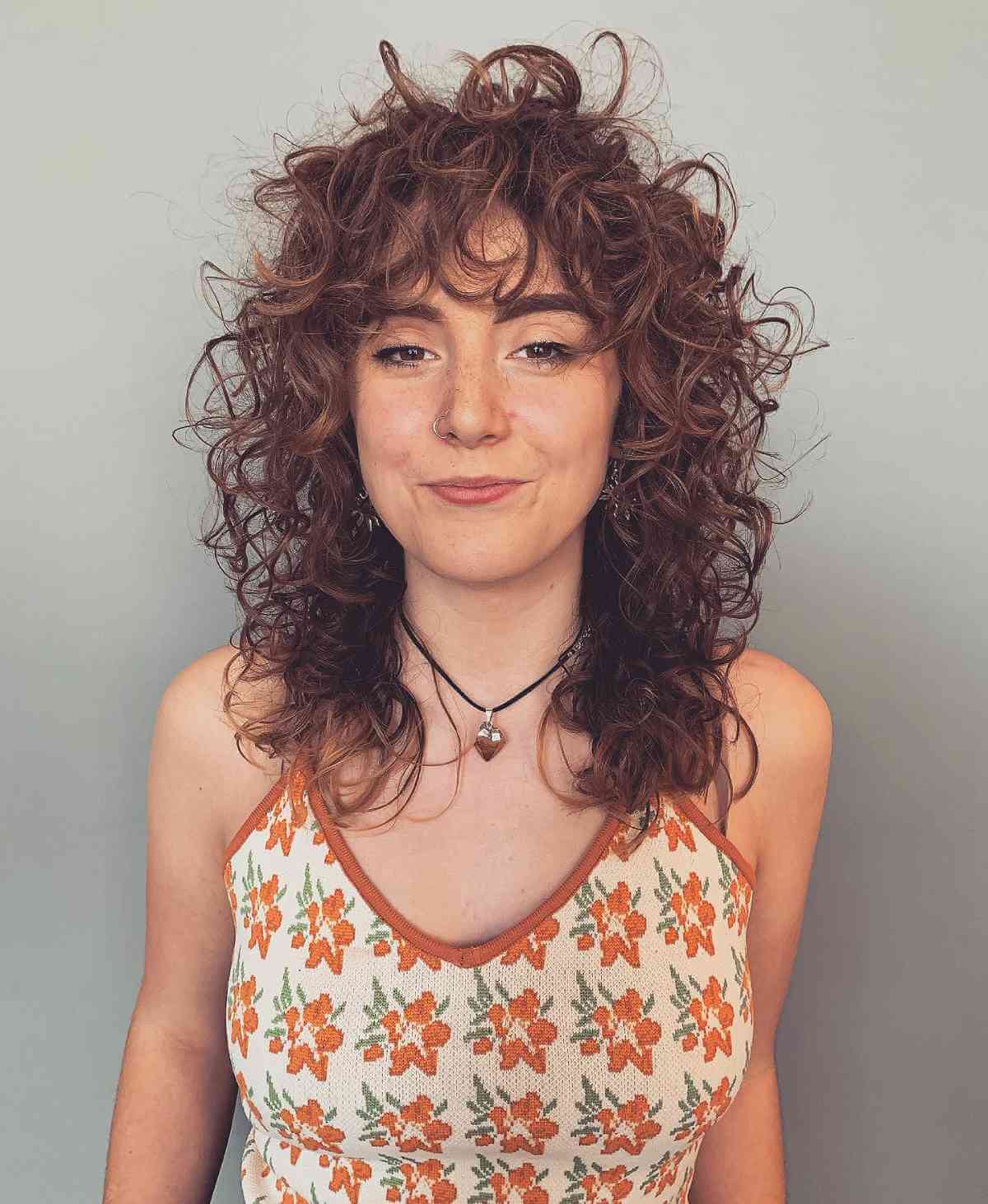 Mid-Length Shaggy Haircut on Curly Brunette Locks