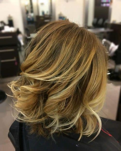 Picture of a sunset blonde with shoulder-length layers