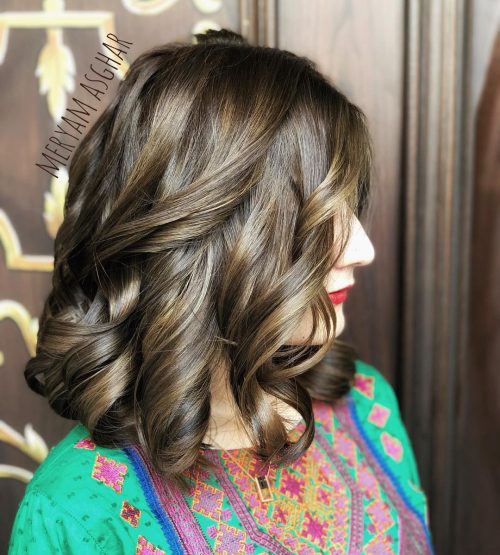 Picture of an adorable ash brown shoulder-length curls