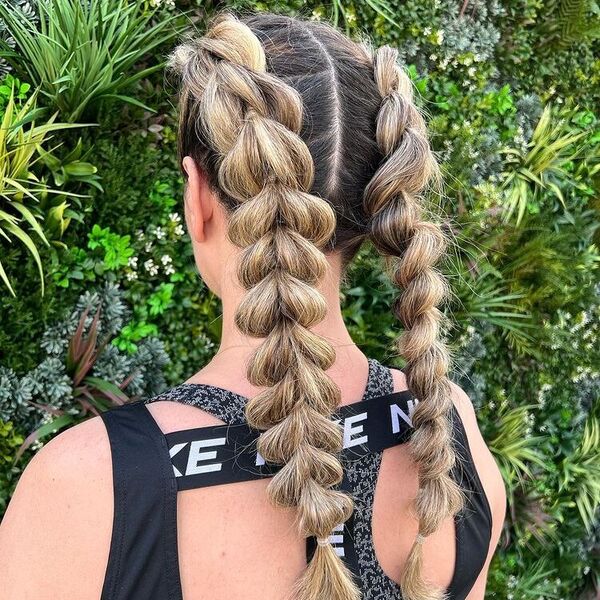 Pull Through Braid Hairstyles- a woman wearing a sports bra