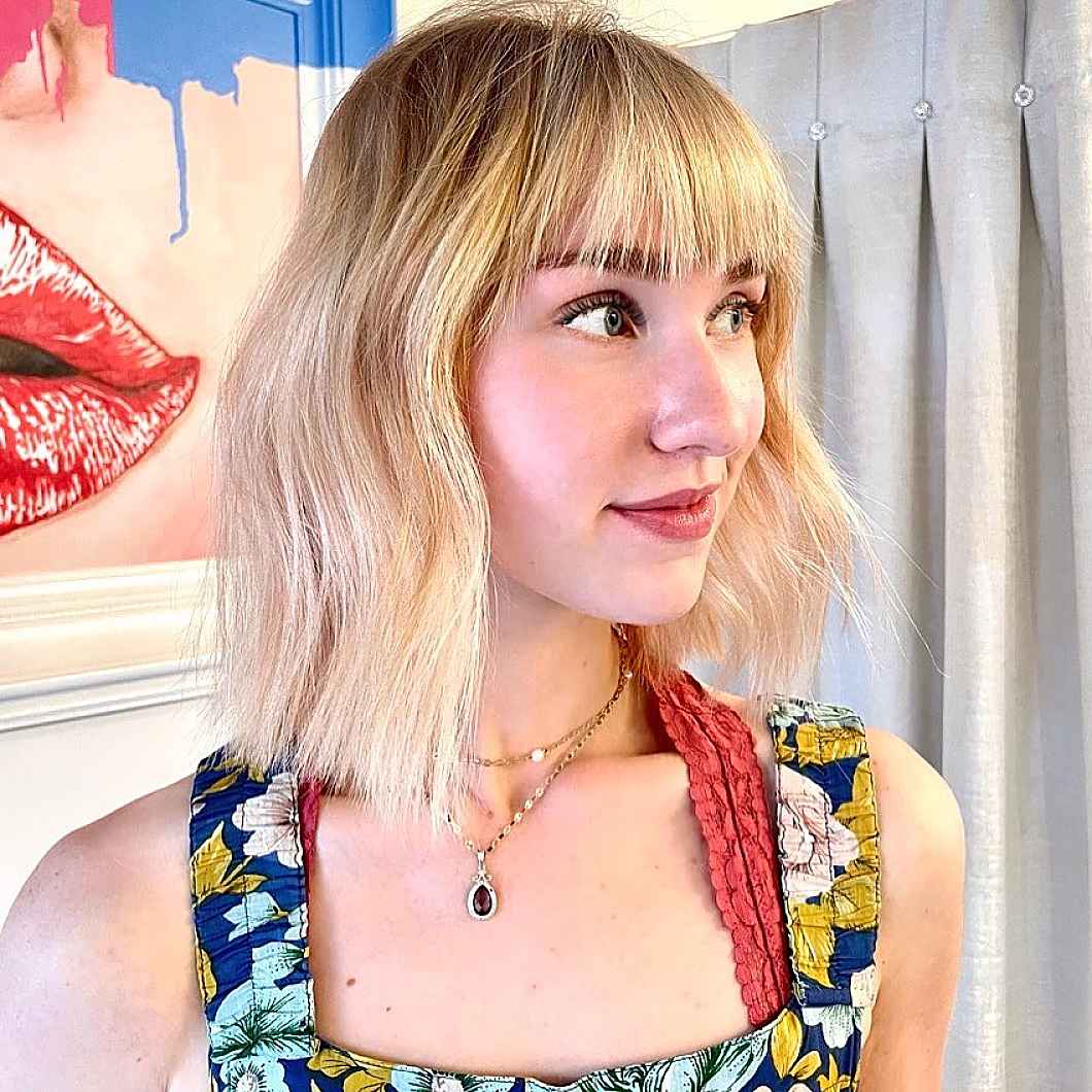 razor cut short blonde bob with bangs