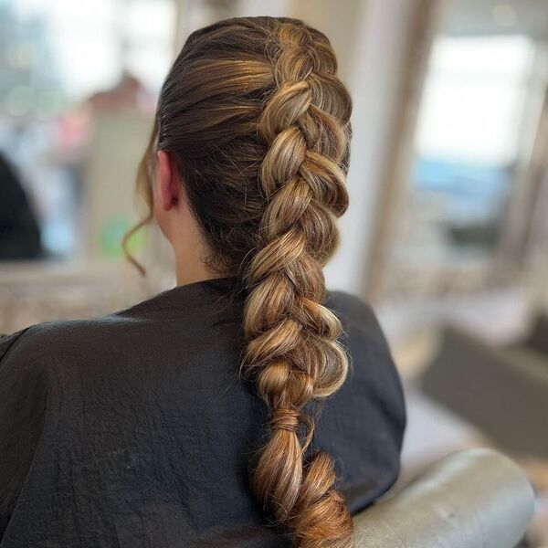 Reverse Braid Styles - a woman wearing a black salon's cape