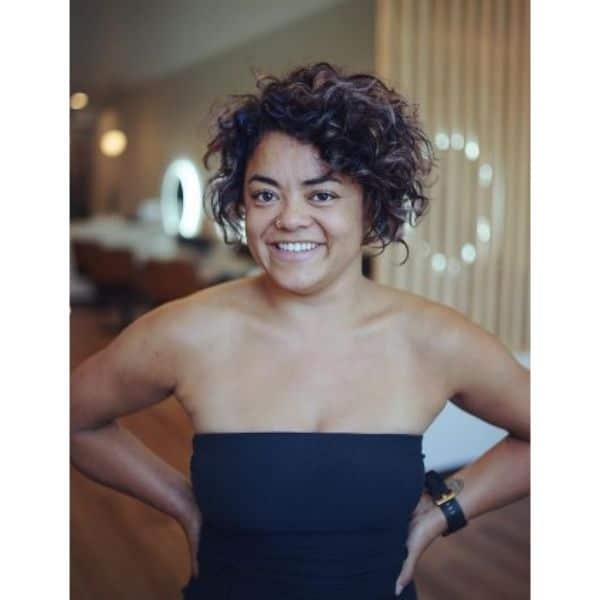 Short Curly Bo With Side Part And Subtle Pink Highlights