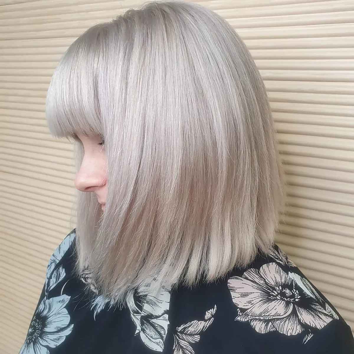 Sleek Straight Haircut with Heavy Bangs