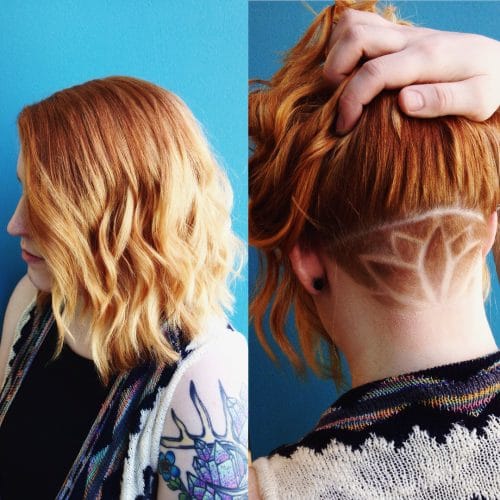 Tattooed undercut on wavy shoulder-length hair