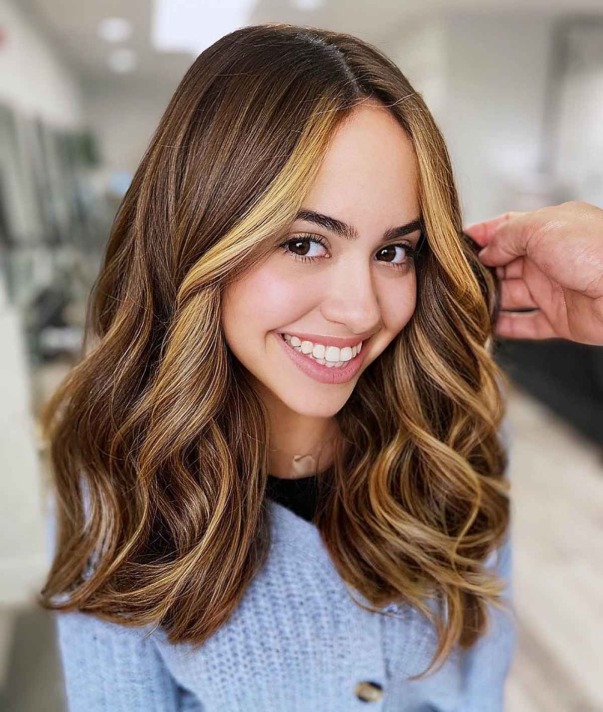 Trendy light caramel highlights on brown hair