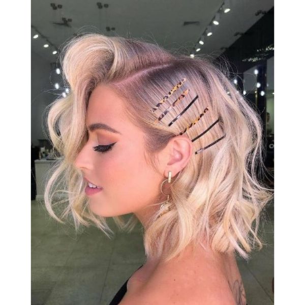 Voluminous Blonde Medium Haircut With Deep SIde Part And Hair Accessories