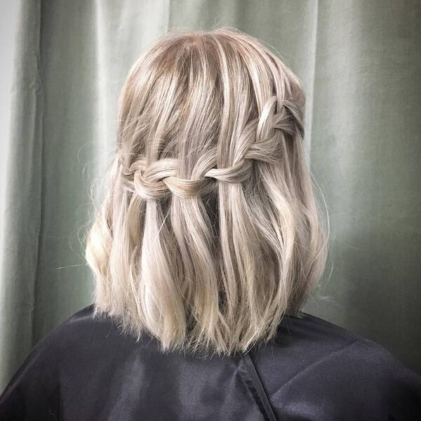 Waterfall Braid Look - a woman wearing a black salon's cape