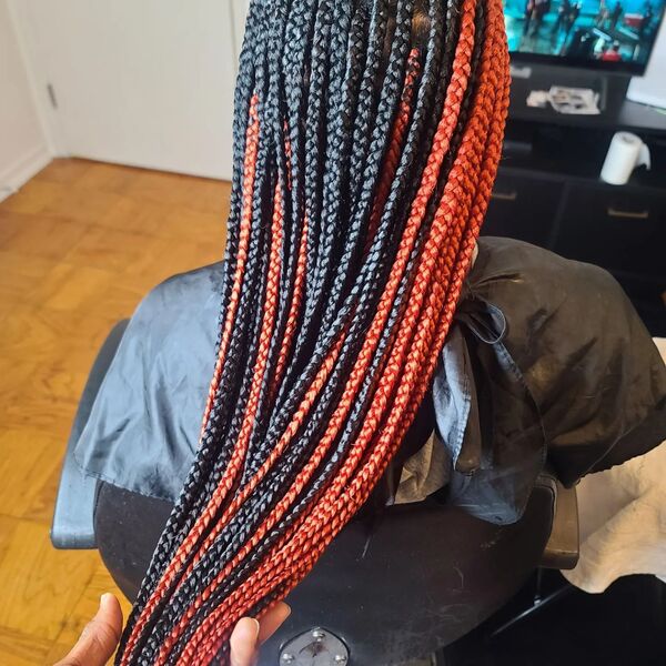 Yarn Braid Hairstyles for Long Hair - a woman sitting in a salon's chair and is wearing a cape