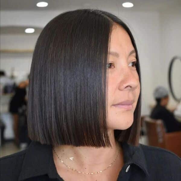 Blunt Classic Style - a woman wearing a black polo shirt and a necklace