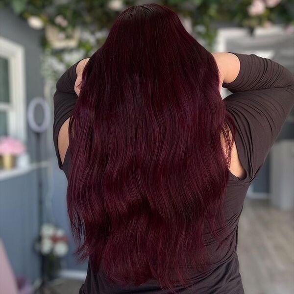 a girl lifting her hair wearing a black long sleeve