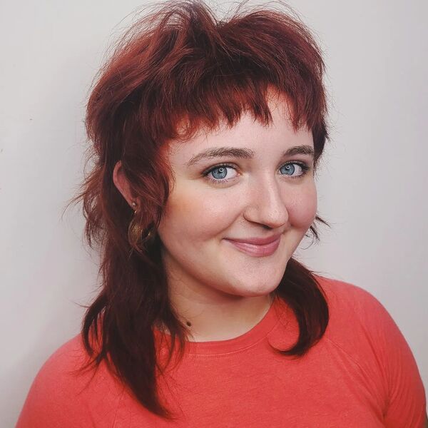 a girl wearing pink shirt - dark red hair