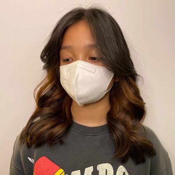 a girl wearing white mask and printed gray shirt