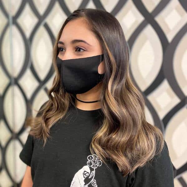 a woman wearing a black facemask and black shirt