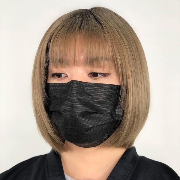 a woman wearing a black facemask