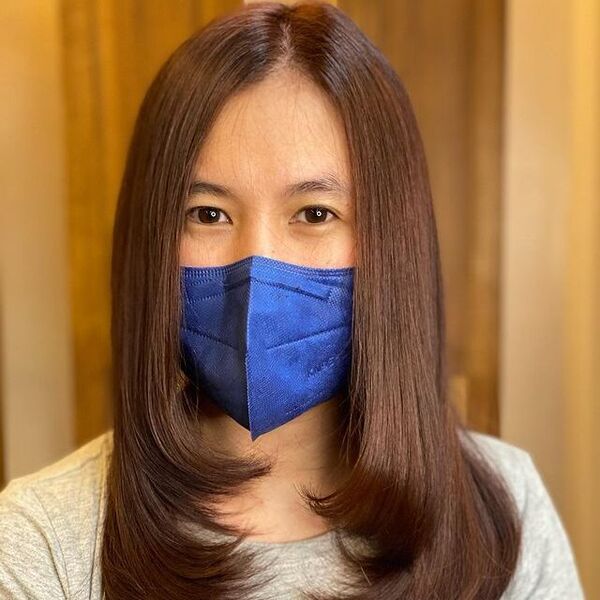 a woman wearing a blue KN95 facemask