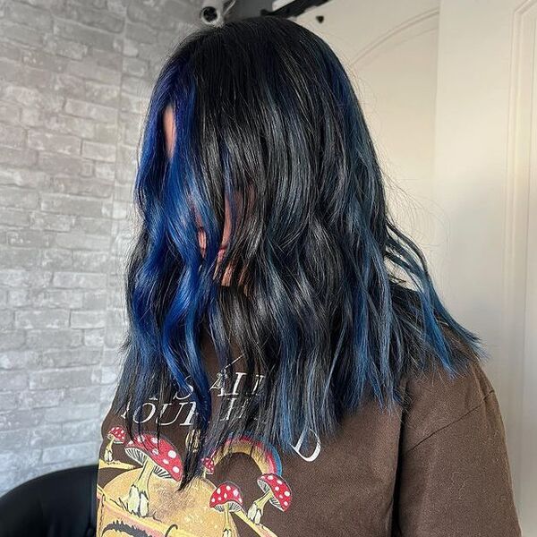 a woman wearing a brown printed shirt blue hair